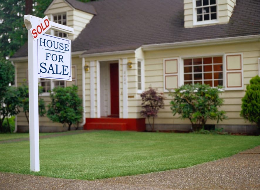 Real estate agent and homeowner reviewing asbestos inspection report before a property sale