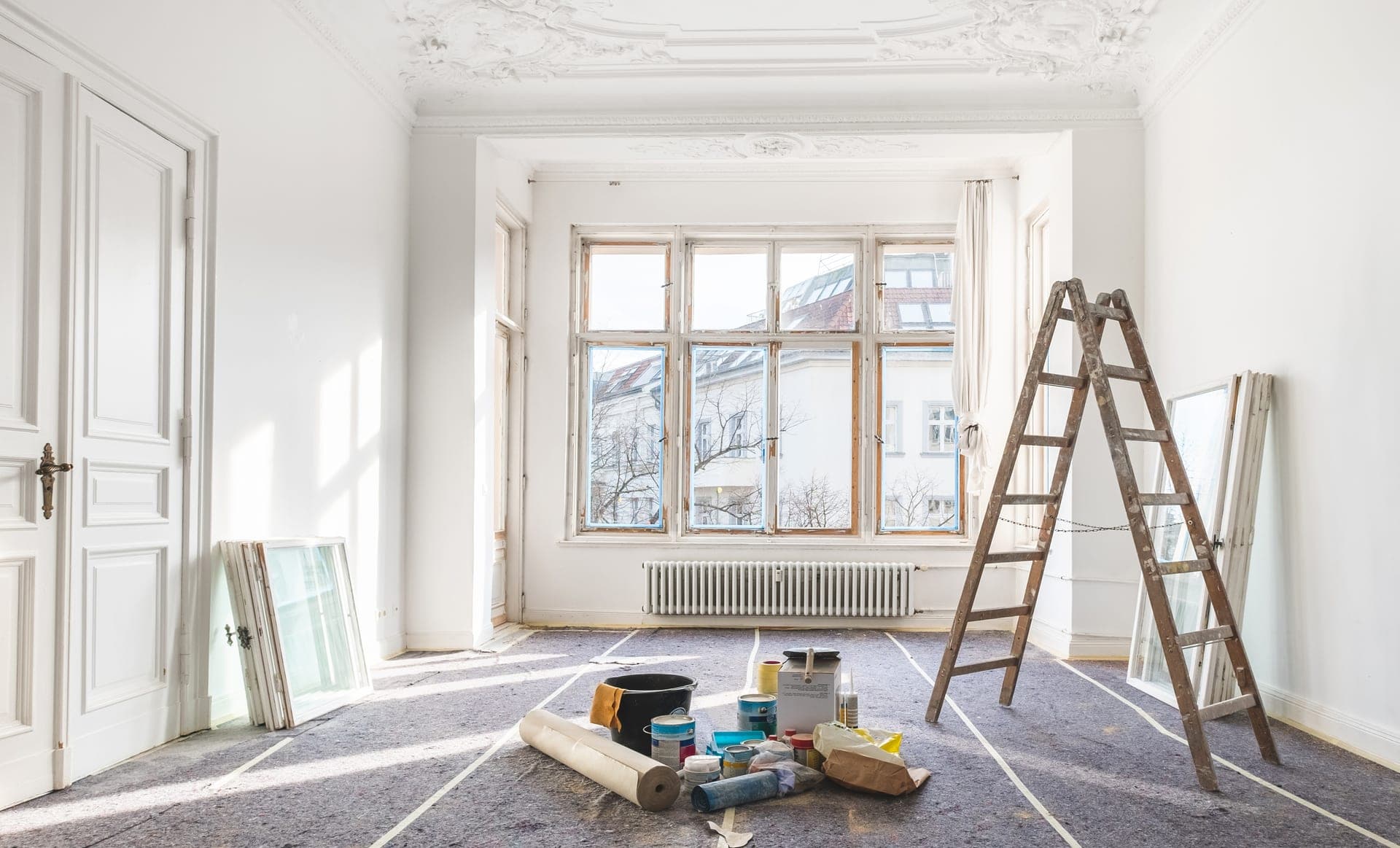 Worker using proper respiratory protection during home renovation to protect indoor air quality