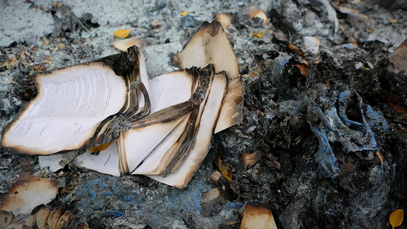 Burned book and personal belongings among ash and soot after a Winnipeg house fire, before contents restoration