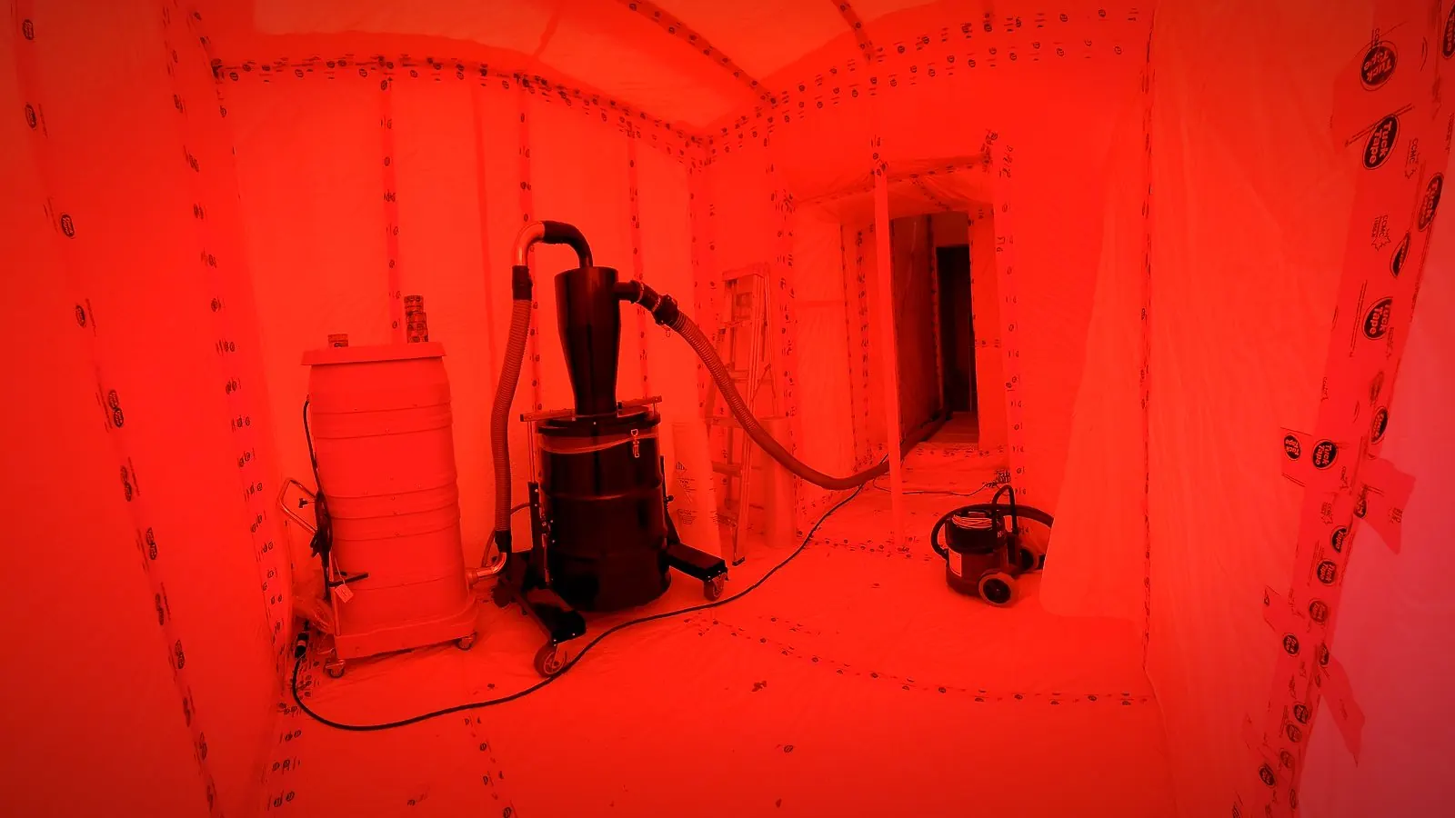 Sealed poly containment with HEPA vacuum and negative-air equipment set up for Level 3 vermiculite removal in Winnipeg