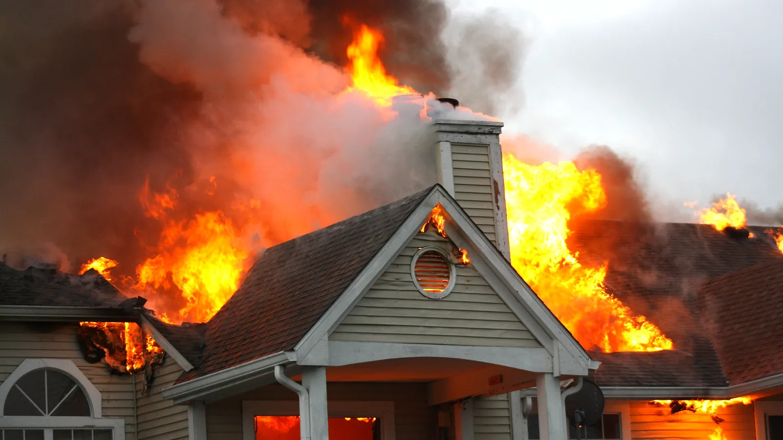 House engulfed in flames during an active structure fire before Relief Restorations fire and smoke damage restoration in Winnipeg