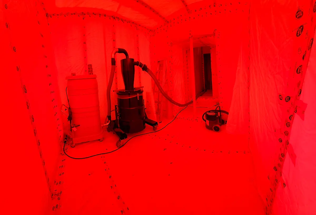 HEPA vacuum and negative-air equipment set up inside containment